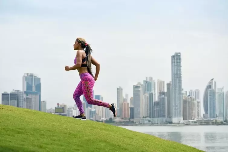 The girl follows the rules of breathing, depending on the technique of running